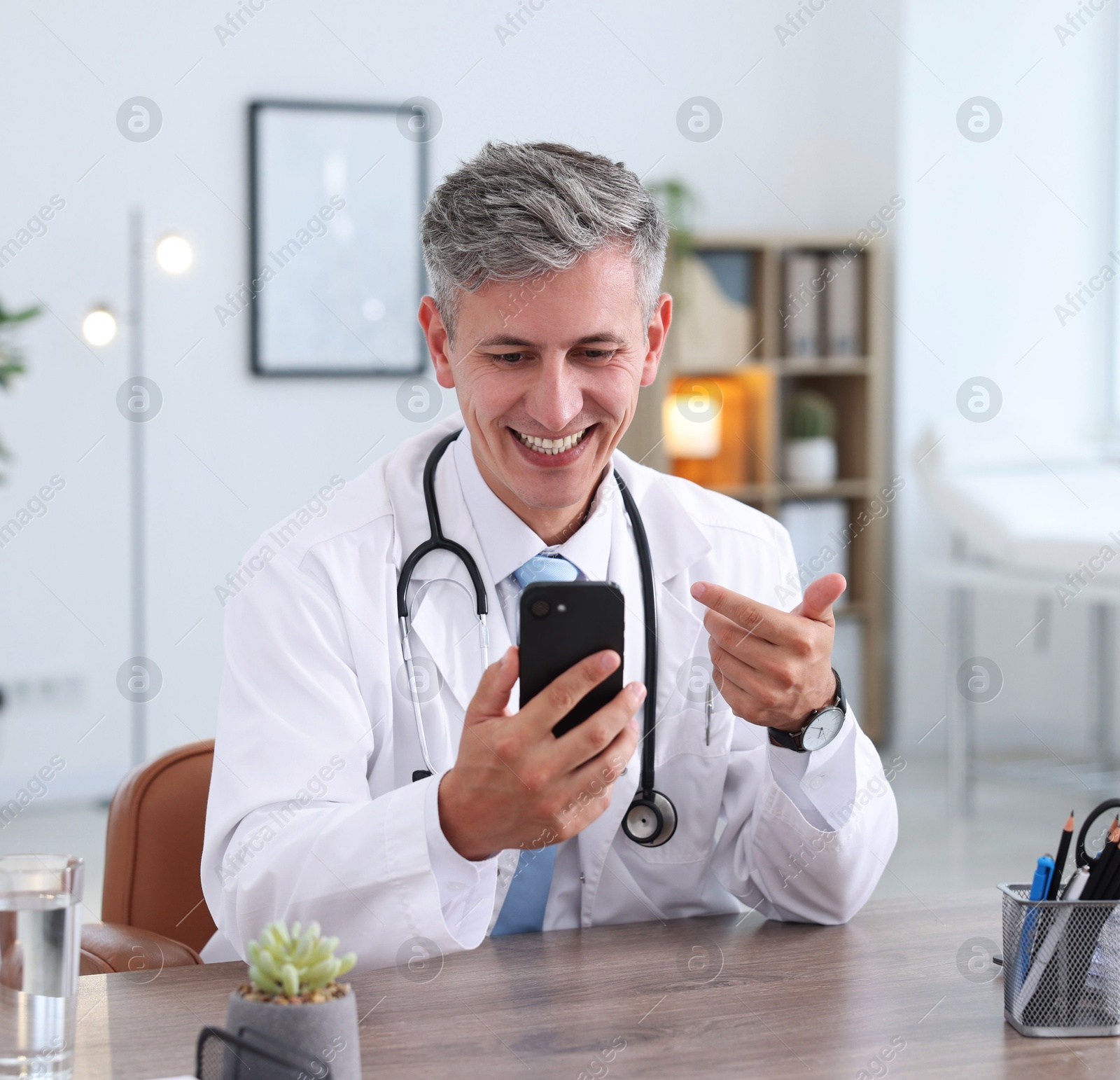 Photo of Telemedicine. Doctor having video call with patient via smartphone indoors