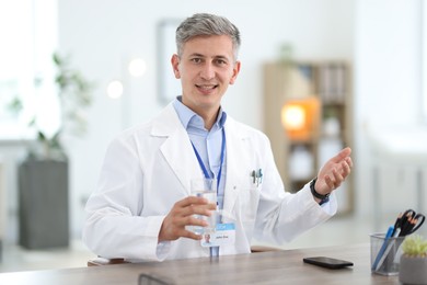 Photo of Telemedicine. Doctor having video call with patient, view from camera
