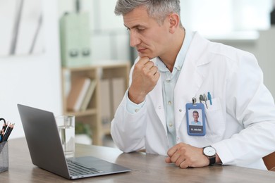 Photo of Telemedicine. Doctor having video call with patient via laptop indoors