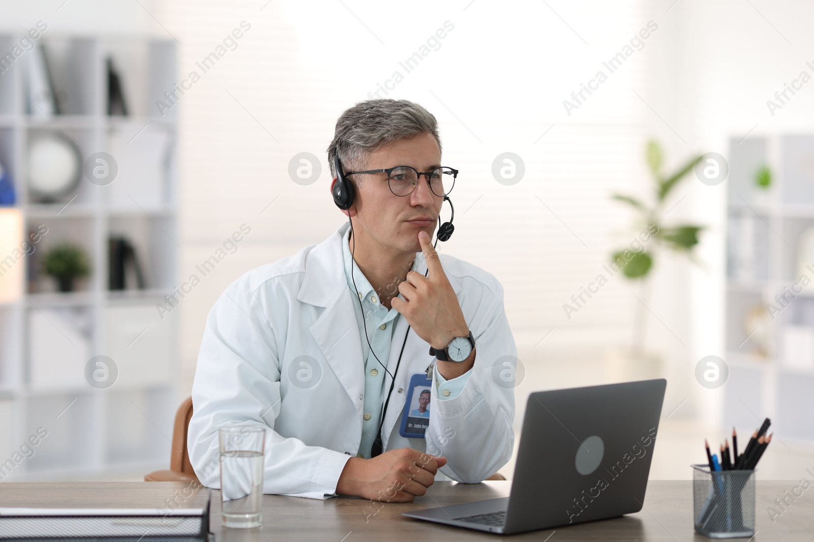 Photo of Telemedicine. Doctor having video call with patient via laptop indoors