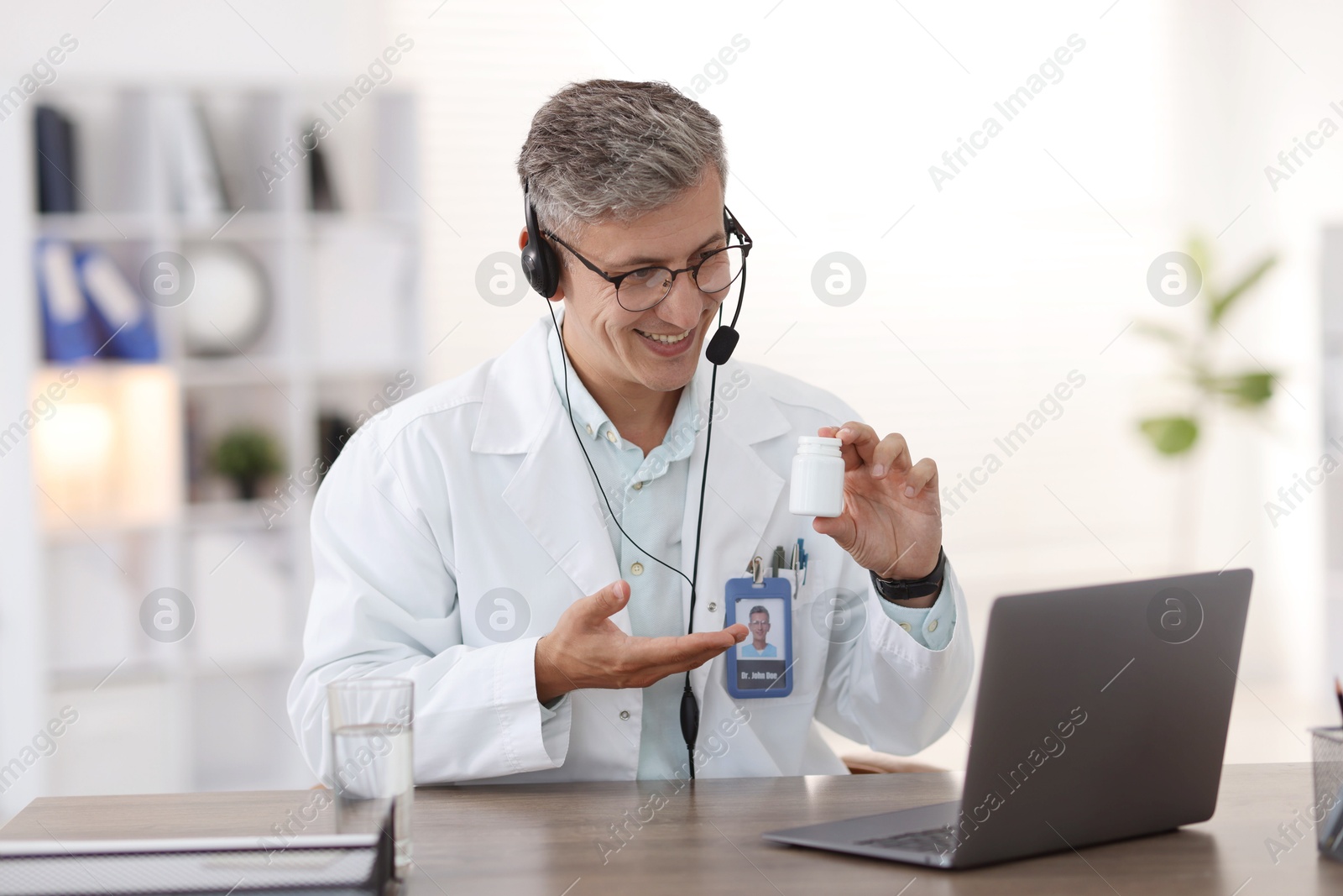 Photo of Telemedicine. Doctor recommending pills to patient during video call via laptop indoors