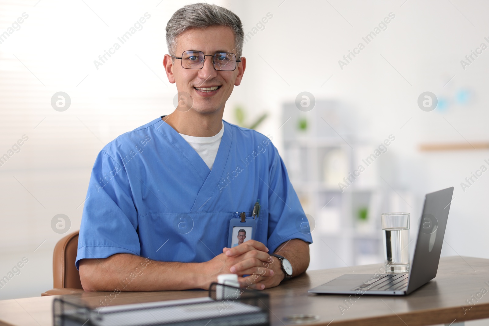 Photo of Telemedicine. Doctor having video call with patient via laptop indoors