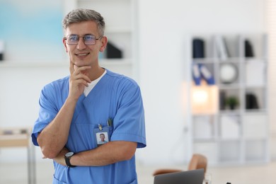Photo of Portrait of doctor in scrubs at clinic