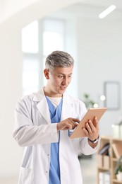 Photo of Telemedicine. Doctor having video call with patient via tablet indoors