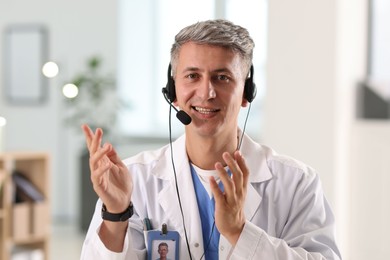 Photo of Telemedicine. Doctor having video call with patient, view from camera