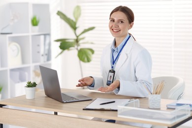 Photo of Telemedicine. Doctor having video call with patient via laptop indoors