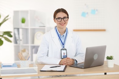 Photo of Telemedicine. Doctor having video call with patient via laptop indoors