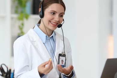 Photo of Telemedicine. Doctor having video call with patient via laptop indoors