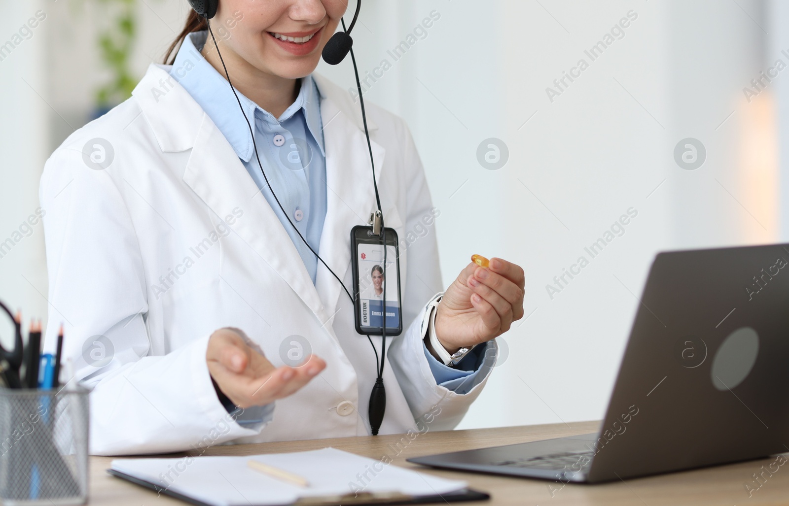 Photo of Telemedicine. Doctor having video call with patient via laptop indoors, closeup