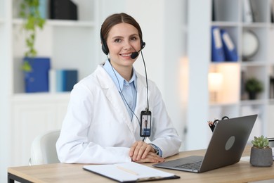 Photo of Telemedicine. Doctor having video call with patient via laptop indoors