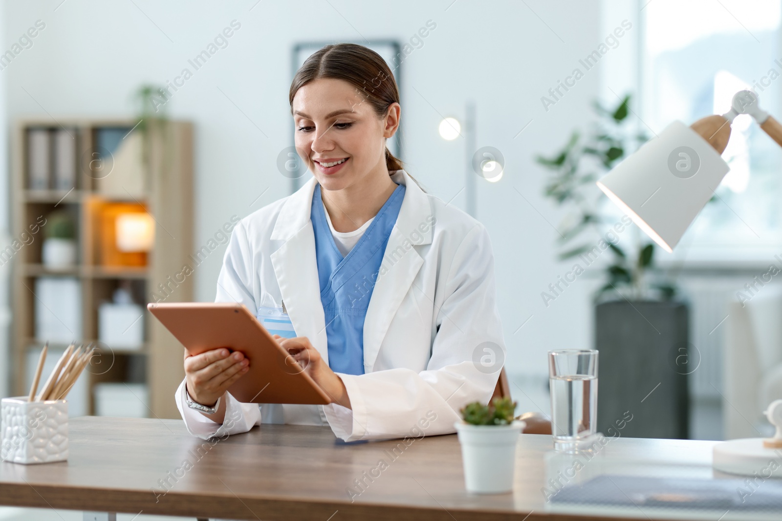 Photo of Telemedicine. Doctor having video call with patient via tablet indoors