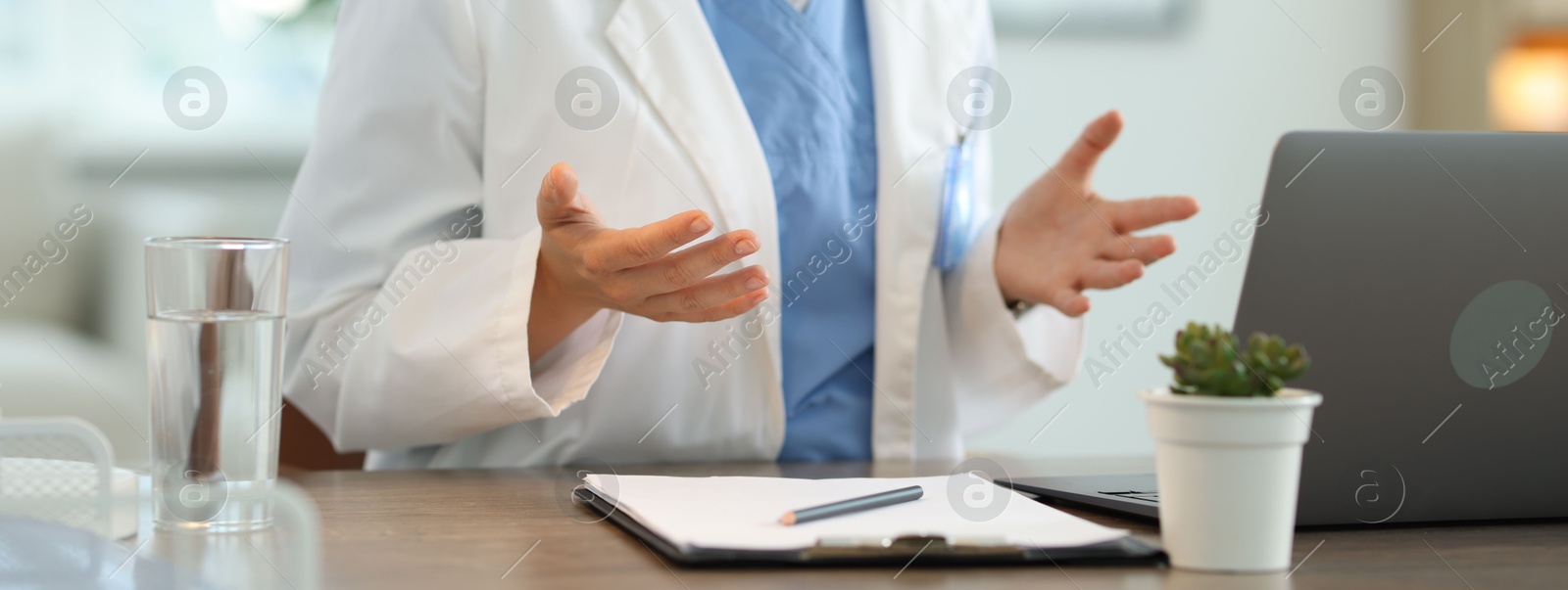 Photo of Telemedicine. Doctor having video call with patient via laptop indoors, closeup