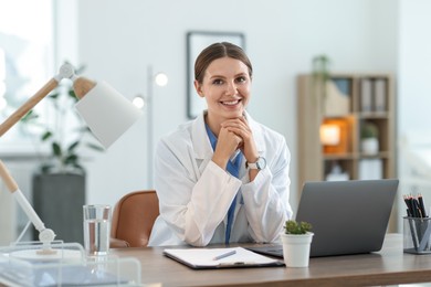 Photo of Telemedicine. Doctor having video call with patient via laptop indoors