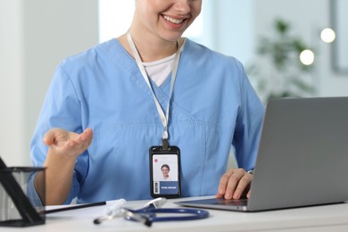 Photo of Telemedicine. Doctor having video call with patient via laptop indoors, closeup