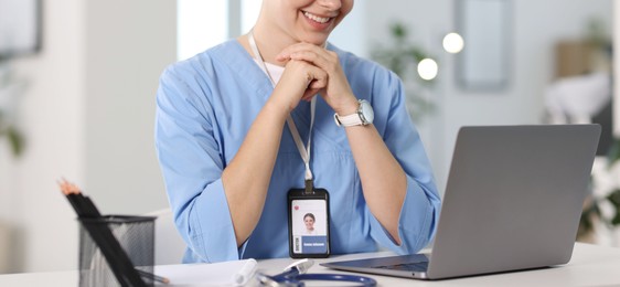 Photo of Telemedicine. Doctor having video call with patient via laptop indoors, closeup