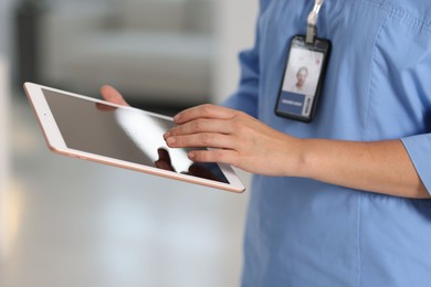 Photo of Telemedicine. Doctor with tablet in office, closeup