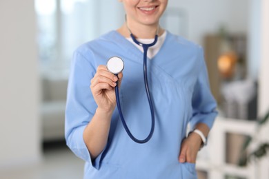 Photo of Telemedicine. Doctor with stethoscope in office, closeup