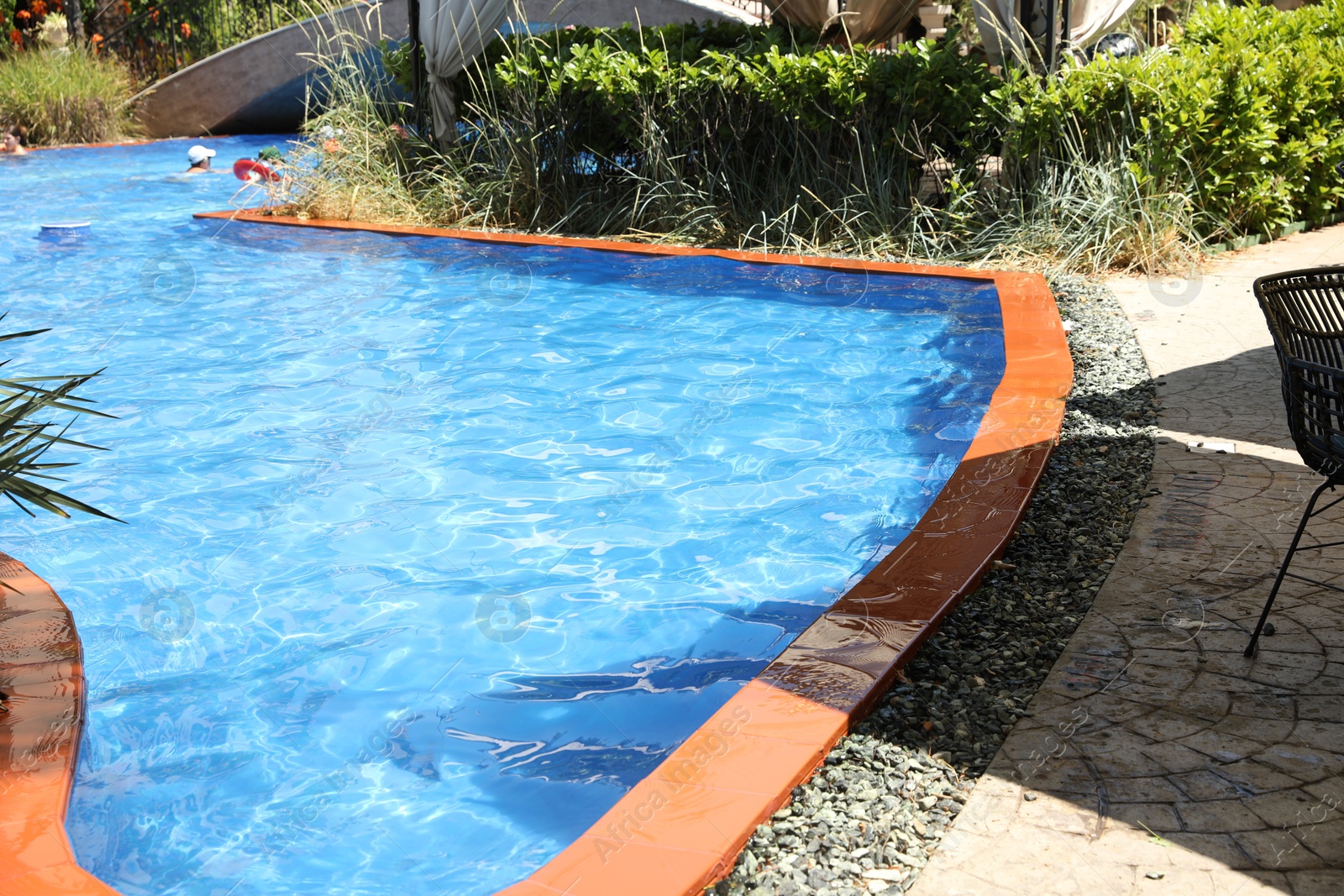 Photo of Outdoor swimming pool with clear water on sunny day, closeup
