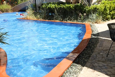 Photo of Outdoor swimming pool with clear water on sunny day, closeup