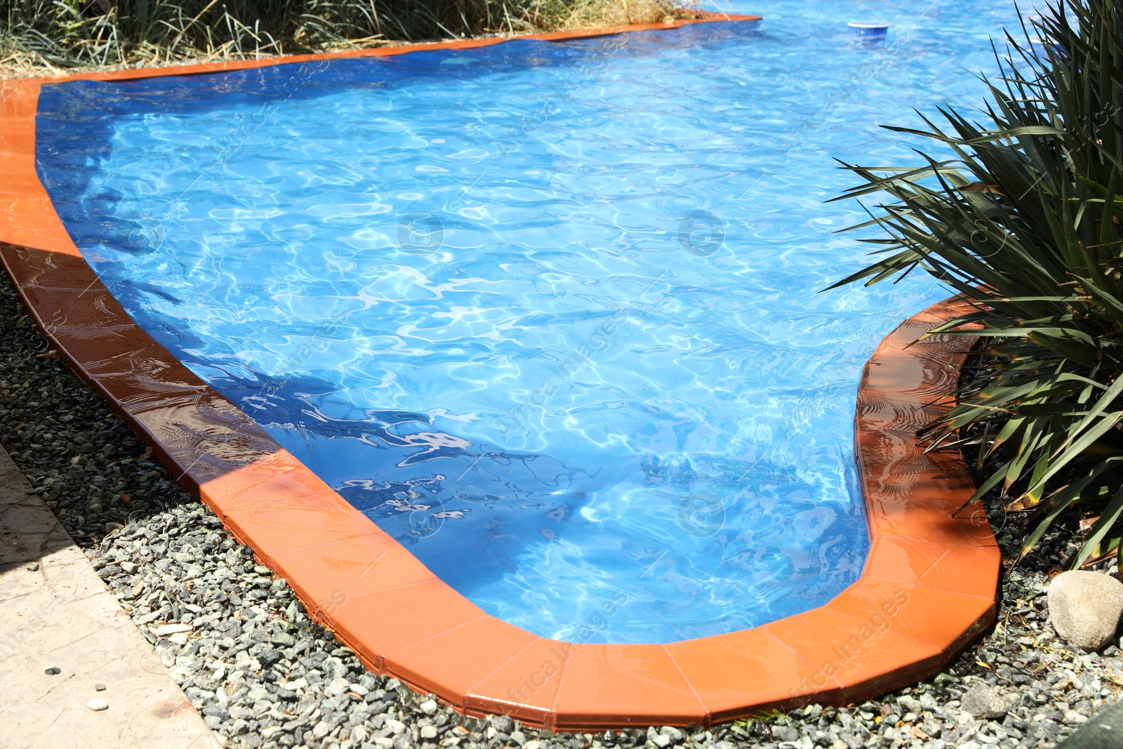 Photo of Outdoor swimming pool with clear water on sunny day, closeup