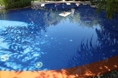 Photo of Outdoor swimming pool with clear water on sunny day