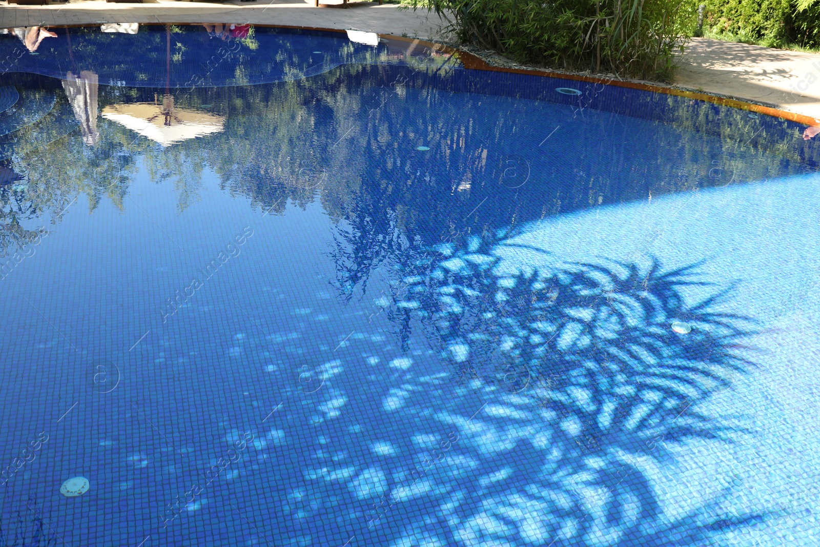 Photo of Outdoor swimming pool with clear water on sunny day