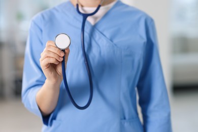 Photo of Telemedicine. Doctor with stethoscope in office, closeup
