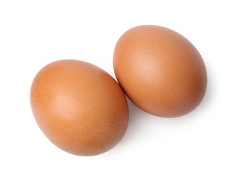 Photo of Two raw chicken eggs isolated on white