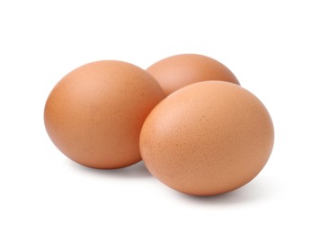 Photo of Three raw chicken eggs isolated on white