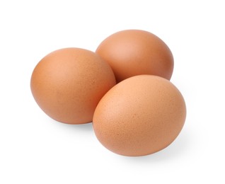 Photo of Three raw chicken eggs isolated on white