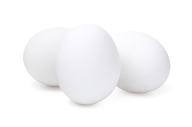 Photo of Three raw chicken eggs isolated on white