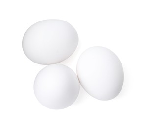 Photo of Raw chicken eggs isolated on white, top view