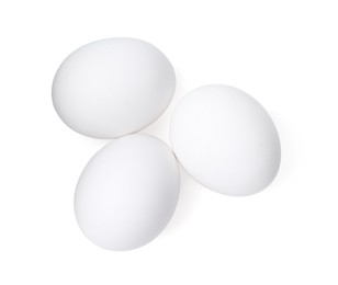 Photo of Raw chicken eggs isolated on white, top view