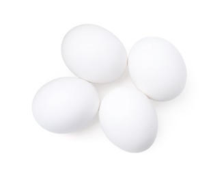 Photo of Raw chicken eggs isolated on white, top view