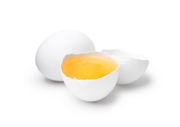 Photo of Whole and broken chicken eggs isolated on white