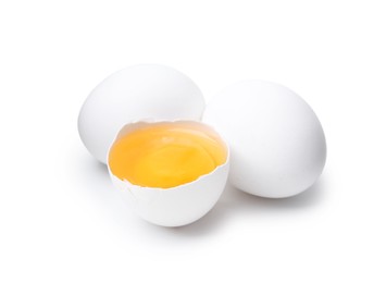 Photo of Whole and broken chicken eggs isolated on white