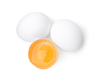 Photo of Whole and broken chicken eggs isolated on white, top view