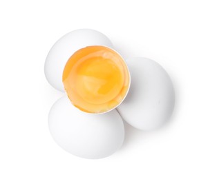 Photo of Whole and broken chicken eggs isolated on white, top view