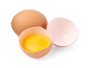 Photo of Whole and broken chicken eggs isolated on white