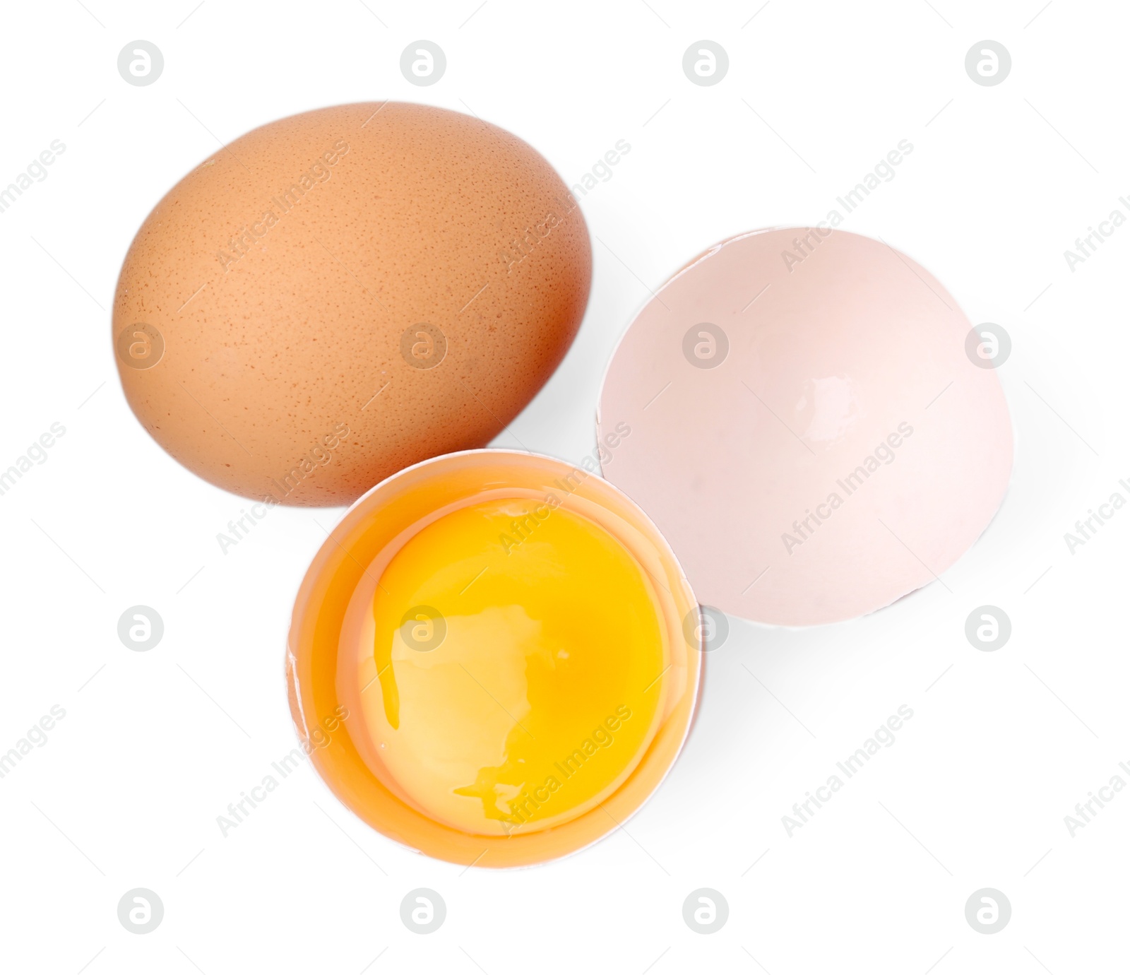 Whole and broken chicken eggs isolated on white, top view Photo of Whole and broken chicken eggs isolated on white, top view