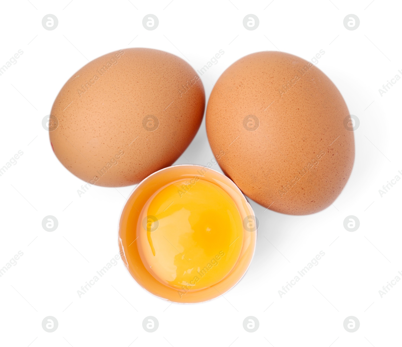Whole and broken chicken eggs isolated on white, top view Photo of Whole and broken chicken eggs isolated on white, top view