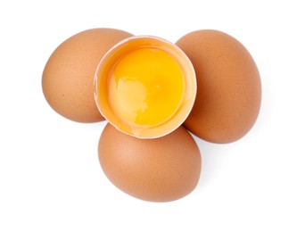 Photo of Whole and broken chicken eggs isolated on white, top view