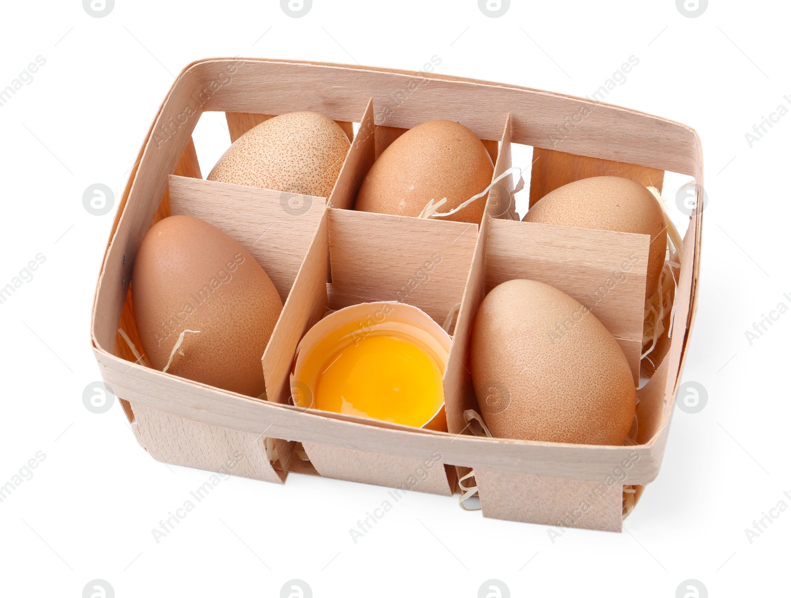 Whole and broken chicken eggs in wooden tray isolated on white Photo of Whole and broken chicken eggs in wooden tray isolated on white