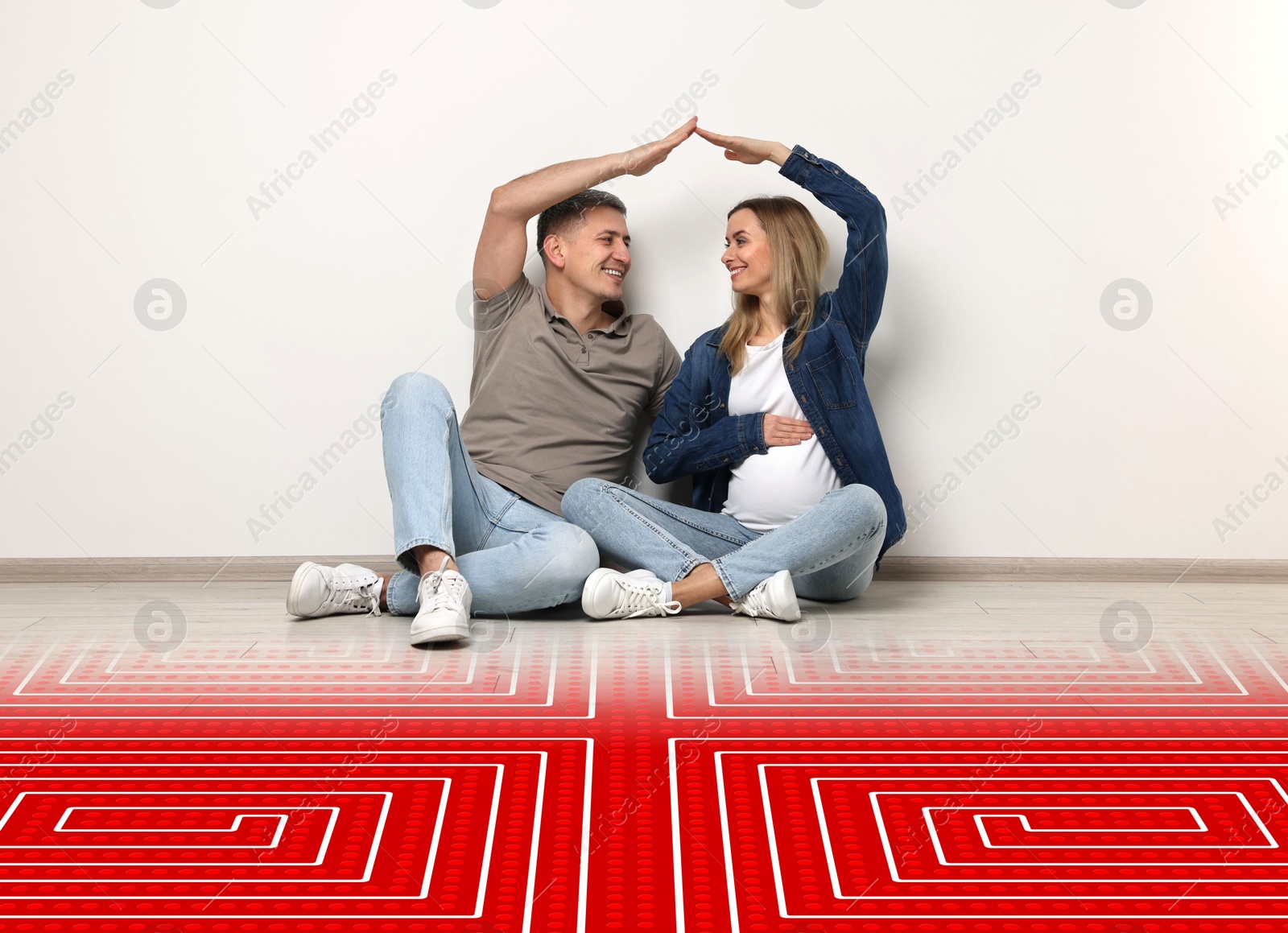 Pregnant woman with her husband making roof with their hands while sitting on warm floor indoors. Illustration of underfloor heating on floor Image of Pregnant woman with her husband making roof with their hands while sitting on warm floor indoors. Illustration of underfloor heating on floor