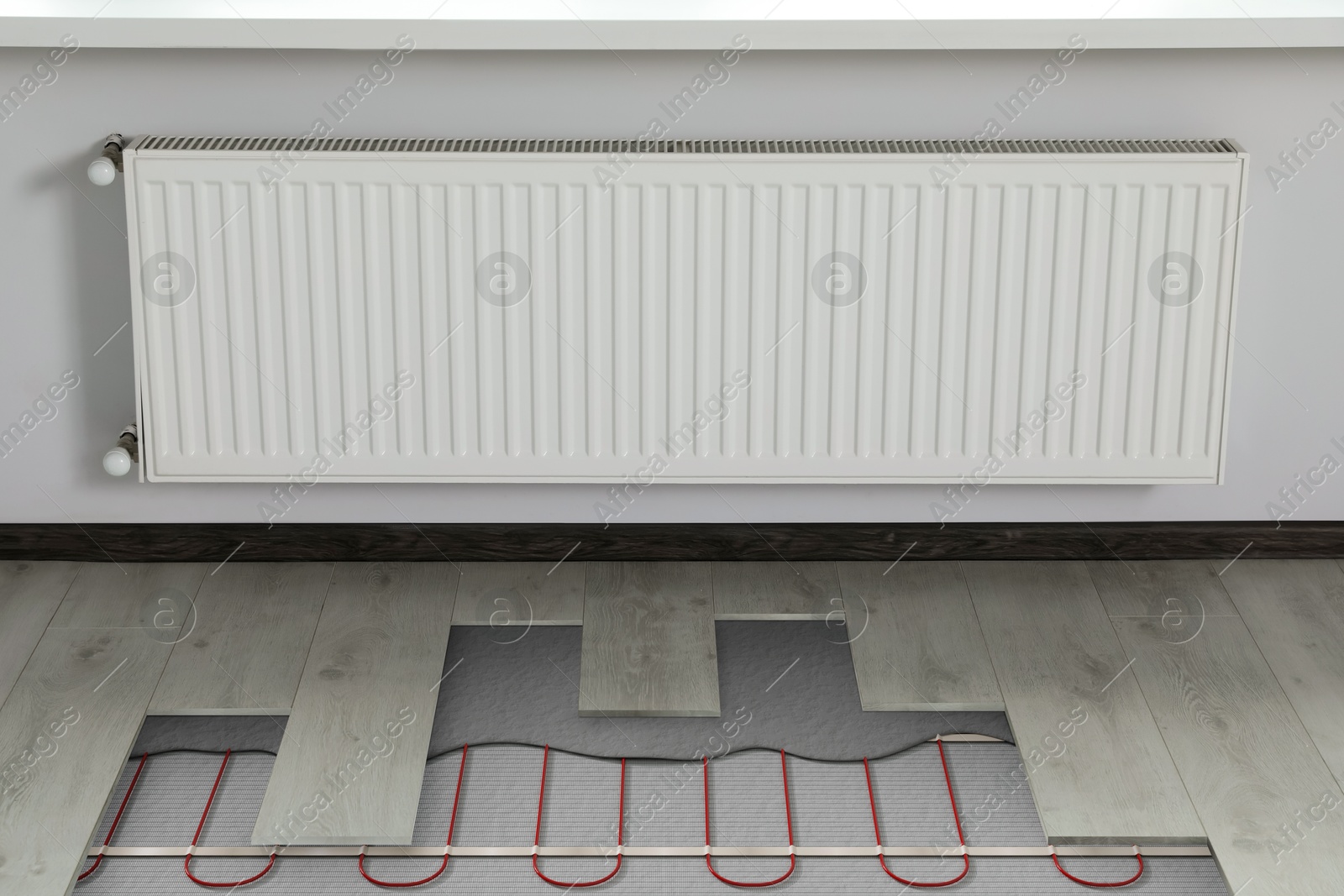 Underfloor heating system installed in room. Pipes seen under laminate Image of Underfloor heating system installed in room. Pipes seen under laminate