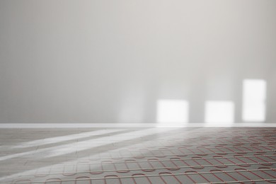 Image of Underfloor heating system seen through laminate, double exposure