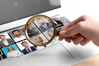 Image of Recruiter looking at candidates' photos through magnifying glass on laptop, closeup. Human resources management
