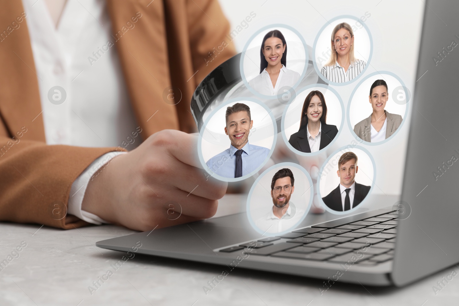 Image of Recruiter looking at candidates' photos through magnifying glass on virtual screen, closeup. Human resources management