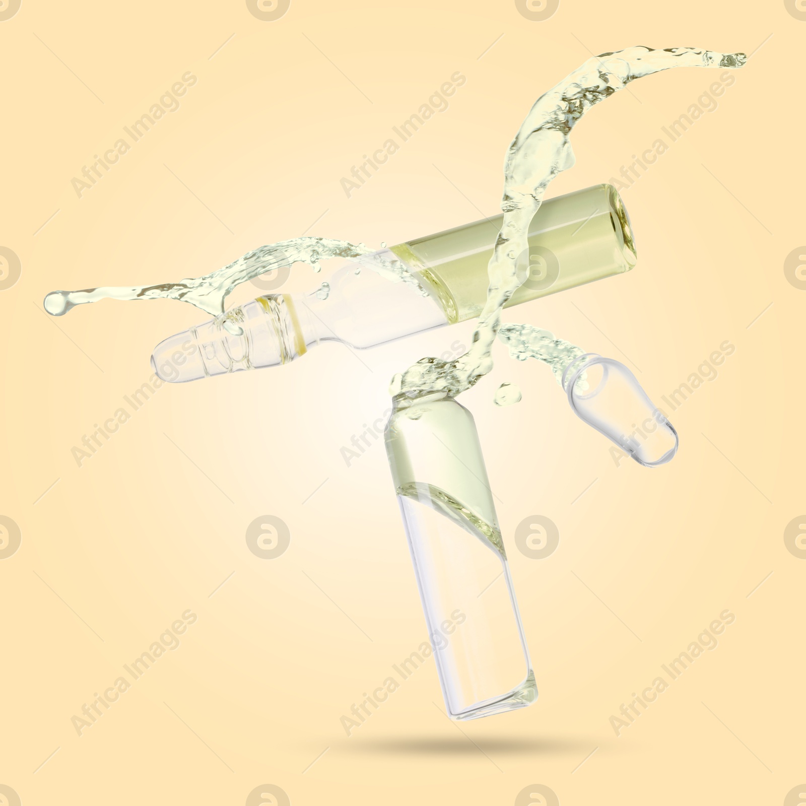 Image of Ampoules and splash of medical or cosmetic liquid in air against beige background