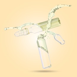 Image of Ampoules and splash of medical or cosmetic liquid in air against beige background